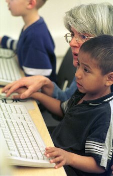 computer class teacher assisting student in computer class